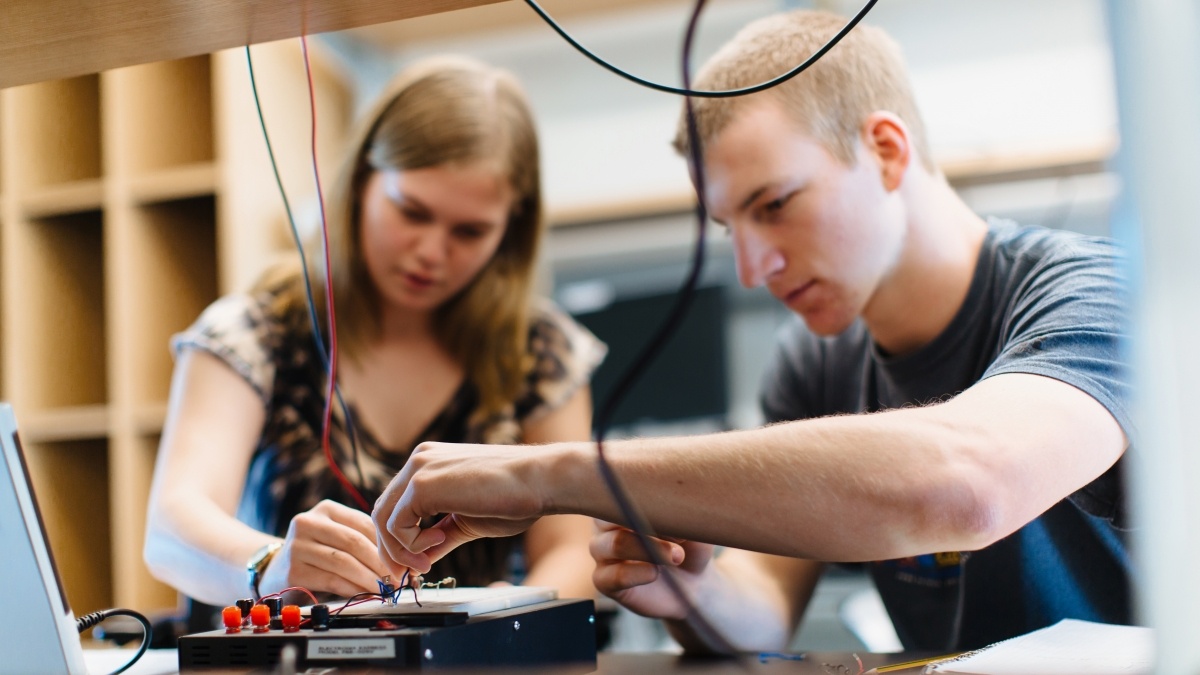 Up close up image of students building electronics